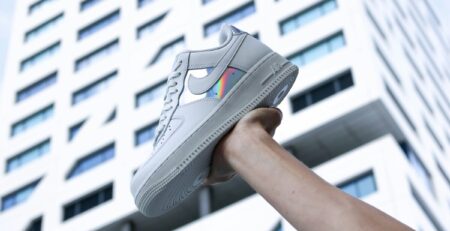 A person holding a Nike Air Force shoe