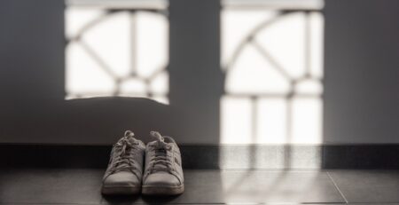 A pair of replica sneakers on the hallway