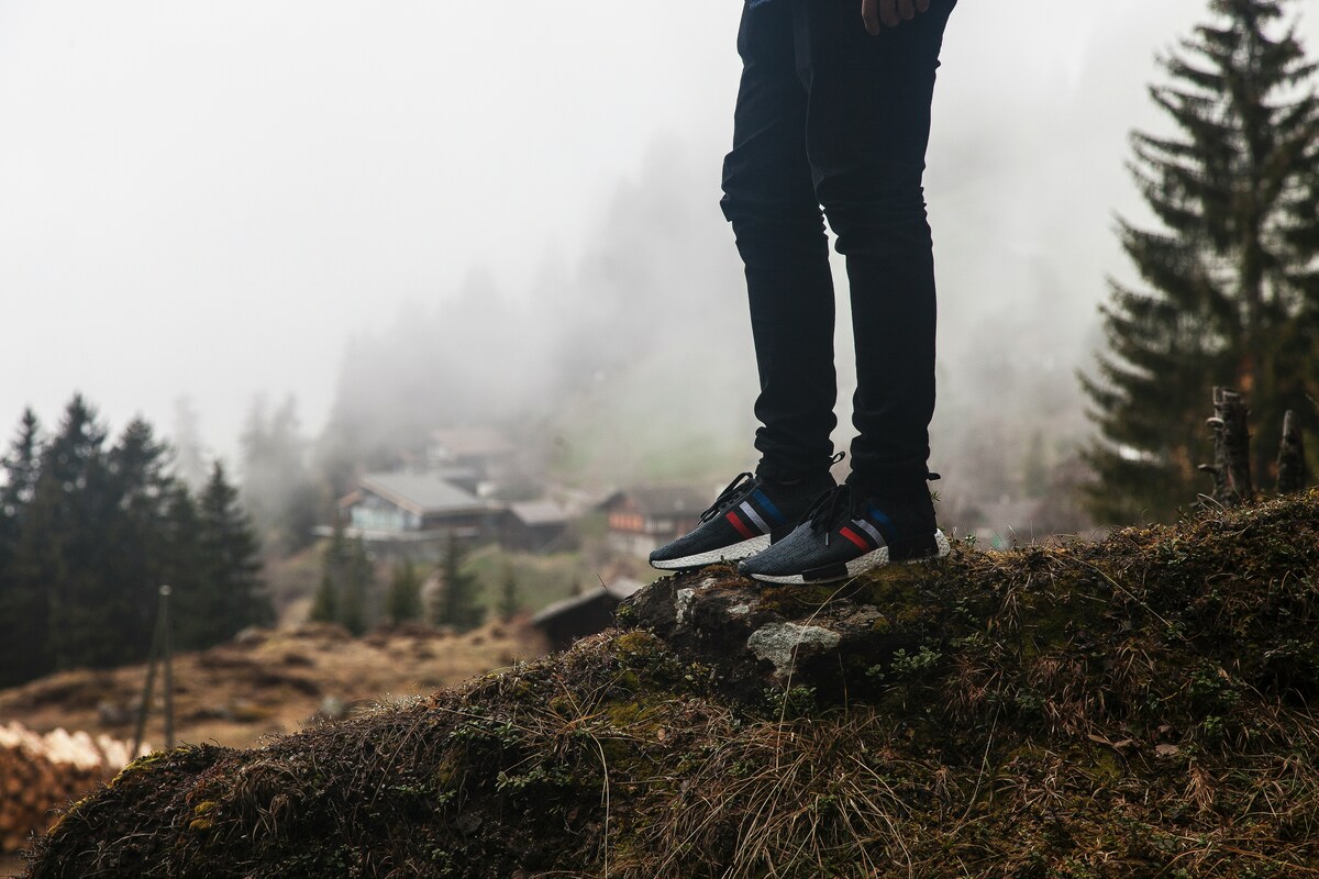 A man on the mountain wearing replica sneakers