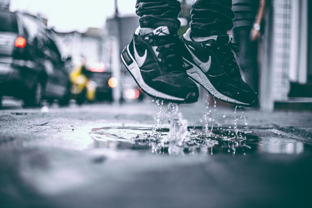 A man jumping while wearing replica shoes.