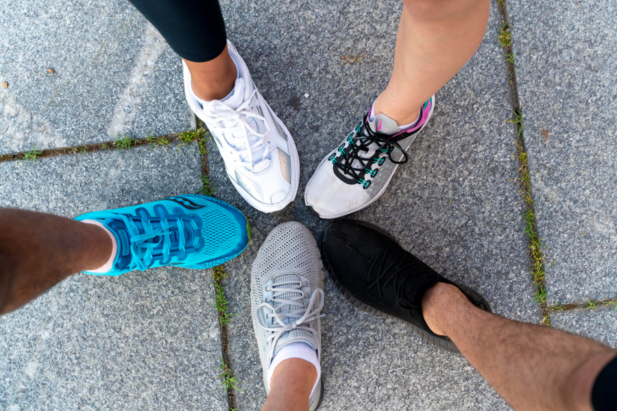 group of friends showing each of their shoes