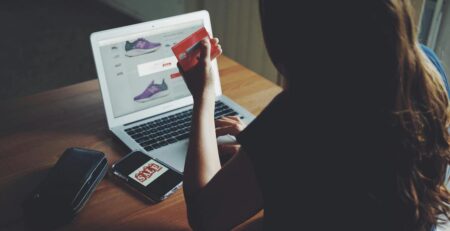 A woman is purchasing replica shoes online